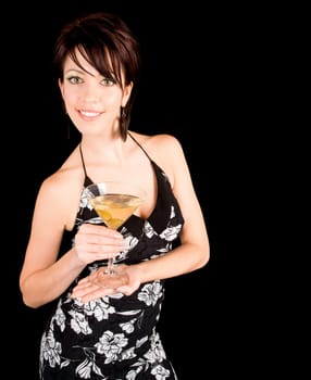 An attractive woman is holding a Martini while looking at the camera.