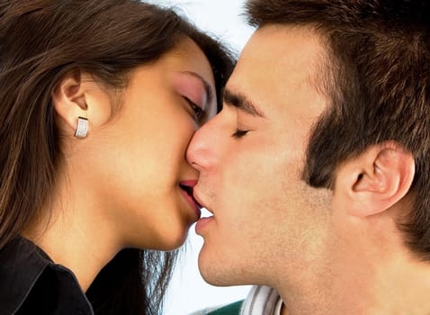 Closeup of a young woman and man kissing