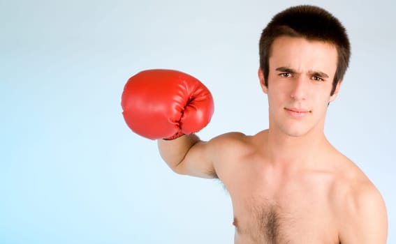 Young boxer ready to punch someone with copy space.