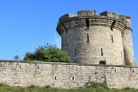 fortifications, tower and tower of a castle on blue sky background