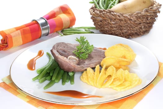 a slice of lamb leg with green beans