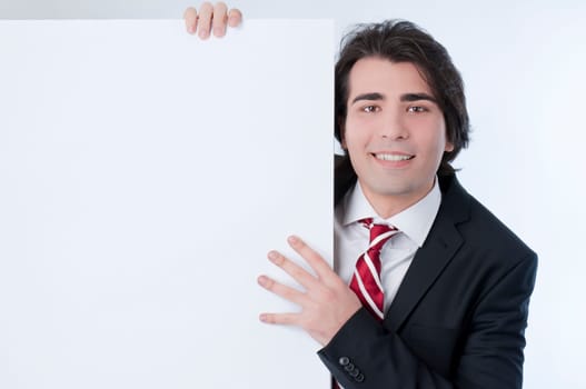 Young man appears from behind a white panel