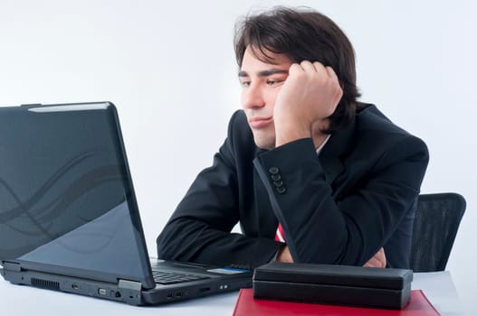 Depressed businessman sitting on his desk