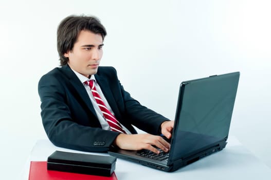 Young businessman browsing the internet from his laptop
