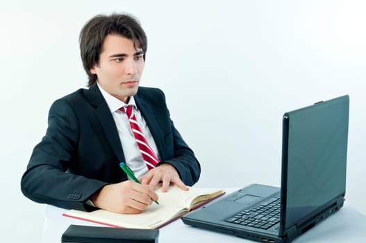 Man taking notes from a laptop on a white background
