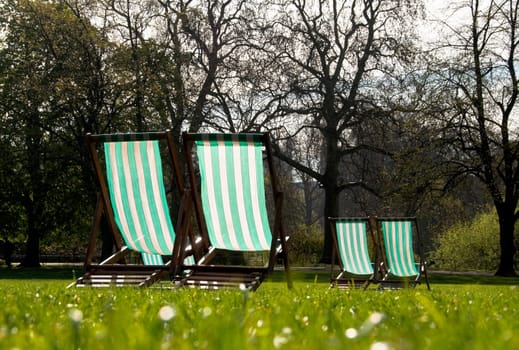 Deck chairs in a park in spring