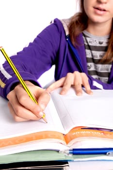 Close up view of a teenager school girl studying the books.