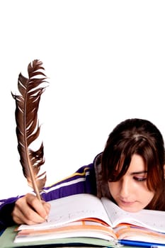 View of a teenager school girl writing on the book with a feather pen.