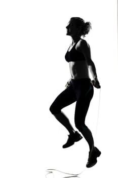 woman workout fitness posture body building jumping rope exercise exercising on studio isolated white background