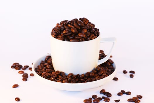A cup and saucer filled with beans