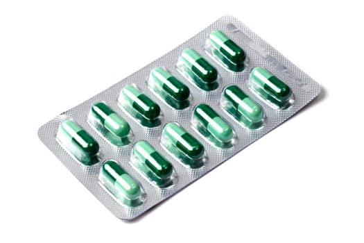 Green capsules packed in blister