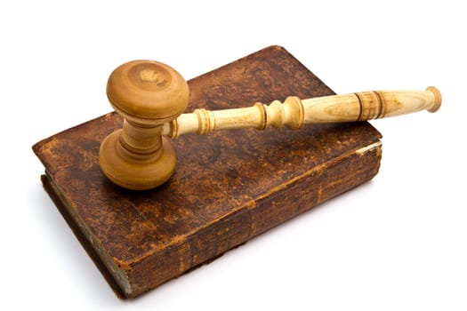 Old book and gavel isolated on white background