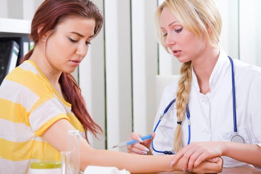 woman doctor make syringe injection to female patient