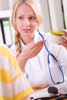 Woman doctor with drug talking to patient at office