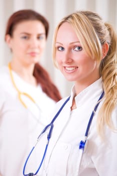 portrait of two smiling doctors in uniform