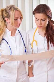two women doctors reading electrocardiogram