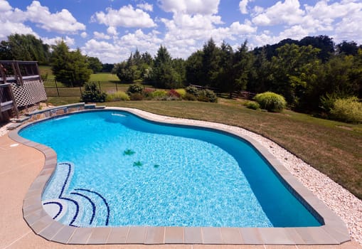 Dramatic back yard swimming pool and garden behind modern single family home