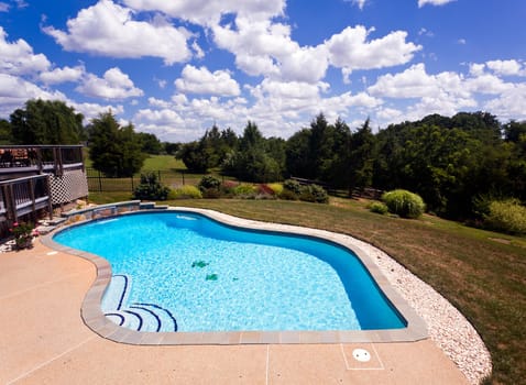 Dramatic back yard swimming pool and garden behind modern single family home