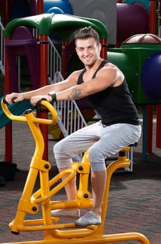 Young man workout on a fitness machine