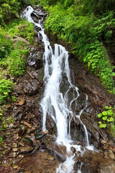 a beautiful waterfall on a mountain slope