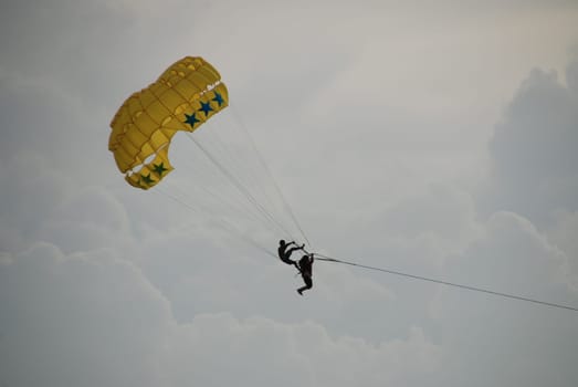 Open-air acrobats in parachute