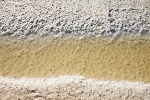 Crystallized salt in an evaporation pond, Algarve, Portugal