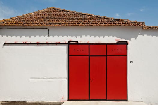 Red sliding gate in a warehouse, Portugal