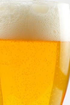 Glass of beer closeup on a white background