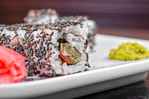 Closeup of Sushi rolls at plate with sesame
