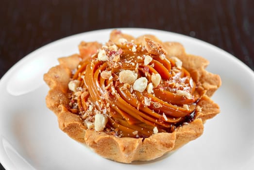 fresh baked cupcake with nuts on a wooden table