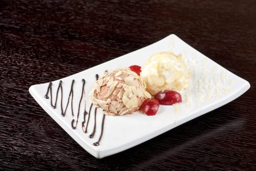 Dessert set of ice-cream with almond, chocolate and grapes