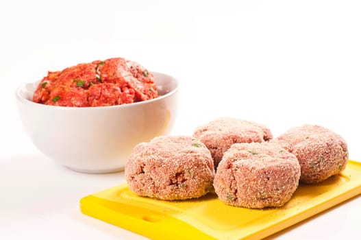 raw minced meatballs on white background