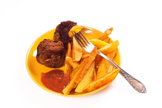 French fries with meatball on plate