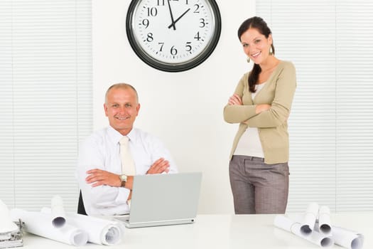 Professional architect people behind office table blueprints crossed arms