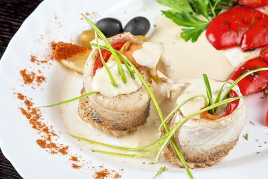 fillet of pikeperch stuffed with trout fish with baked pepper, tomato and leek