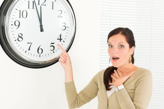 Punctual businesswoman young attractive pointing at clock portrait