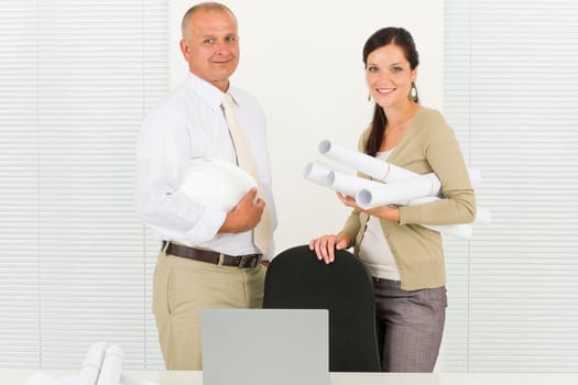Professional architect people behind office table blueprints portrait