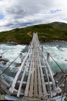 Suspension bridge over a mountain stream