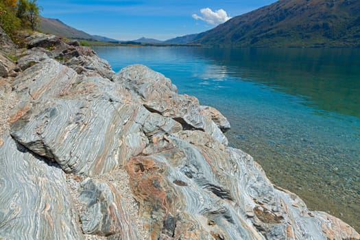 View of the clear waters and mountains at lake Wakatipu, New Zealand