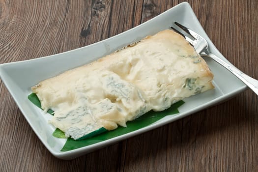 blue cheese on wooden background