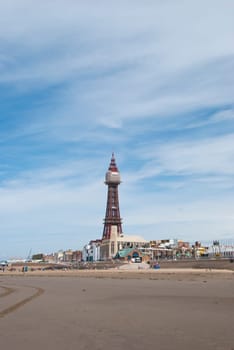 The Famous Tower of Blackpool taken from the beach under a blue sky