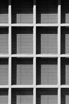 venetian blinds behind white wooden window frames