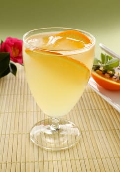Sweet orange cocktail with ice and slices of fresh orange ready to serve.