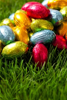 Close-up on chocolate Easter eggs on grass.