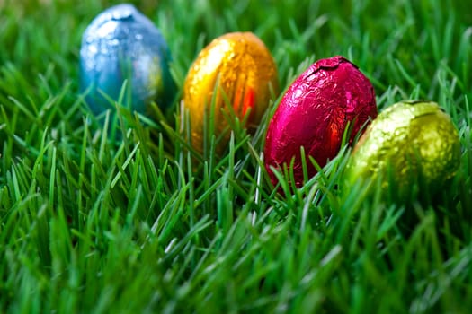 Close-up on chocolate Easter eggs on grass.