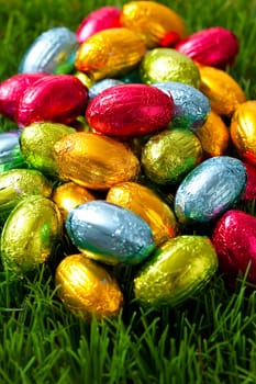 Close-up on chocolate Easter eggs on grass.