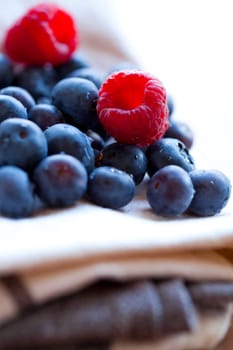 Close-up of delicious fresh blueberries and raspberries. Studio shot.