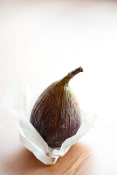 Delicious fresh fig on a wooden table. Studio shot.