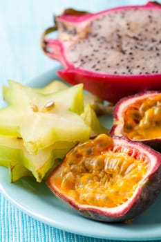 Tropical fruit plate of Carambola, Pitahaya and passion fruit.