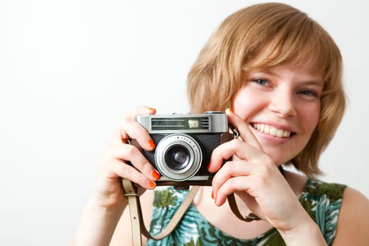 Young woman holding an old vintage camera